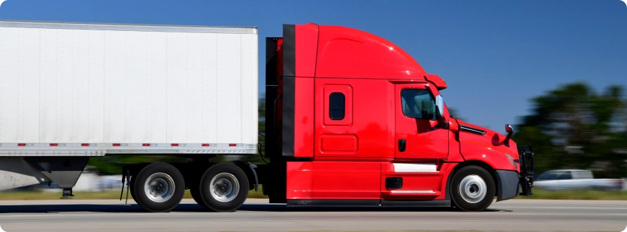 A big red trailer running on the road