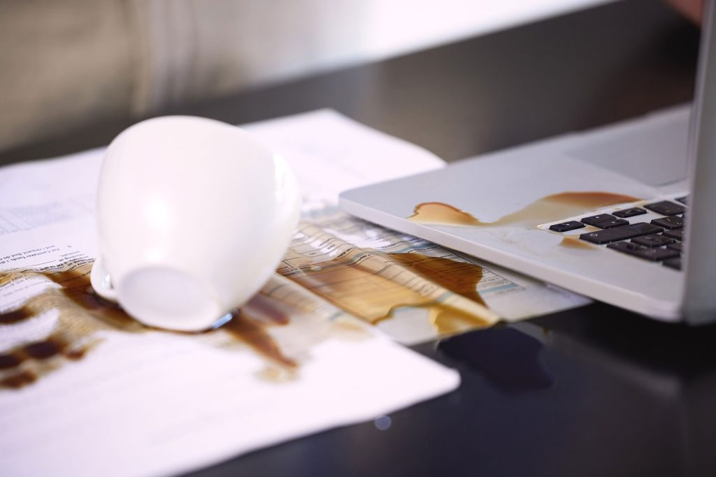 coffee spilt over a laptop and laptop